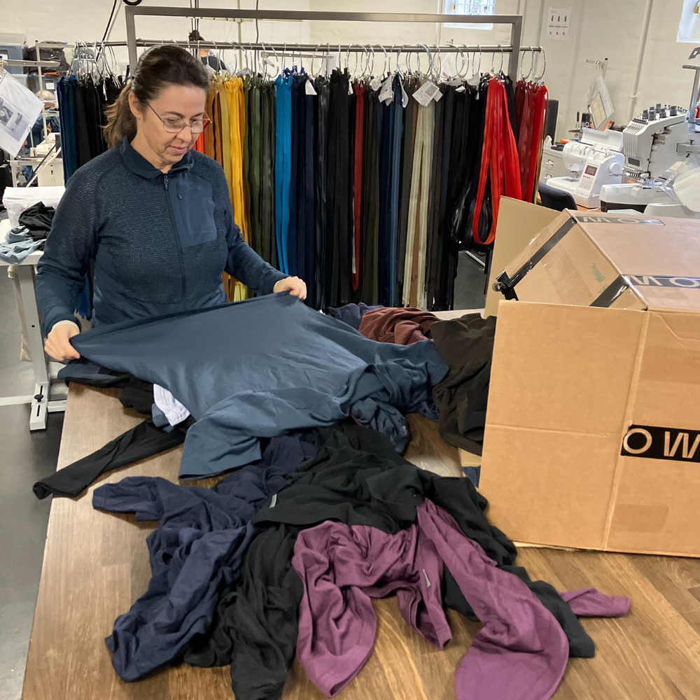 Fleur sorting returned LOOW garments in her workshop