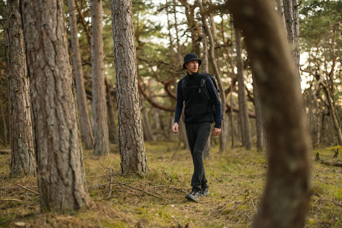 Hiker on a forest path in LOOW merino