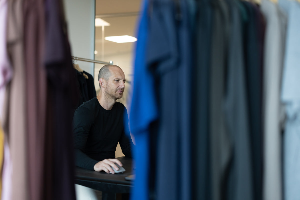 Anders Lorentzen at his desk between racks of LOOW merino samples