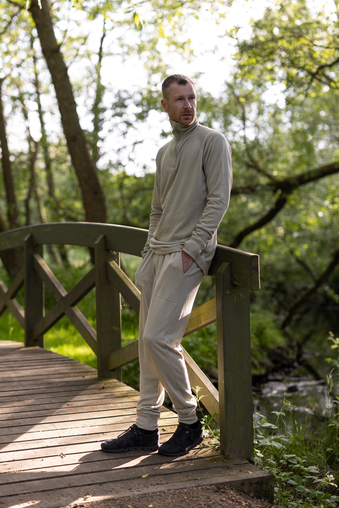 A relaxed moment outdoors in a light LOOW merino zip-neck and trousers